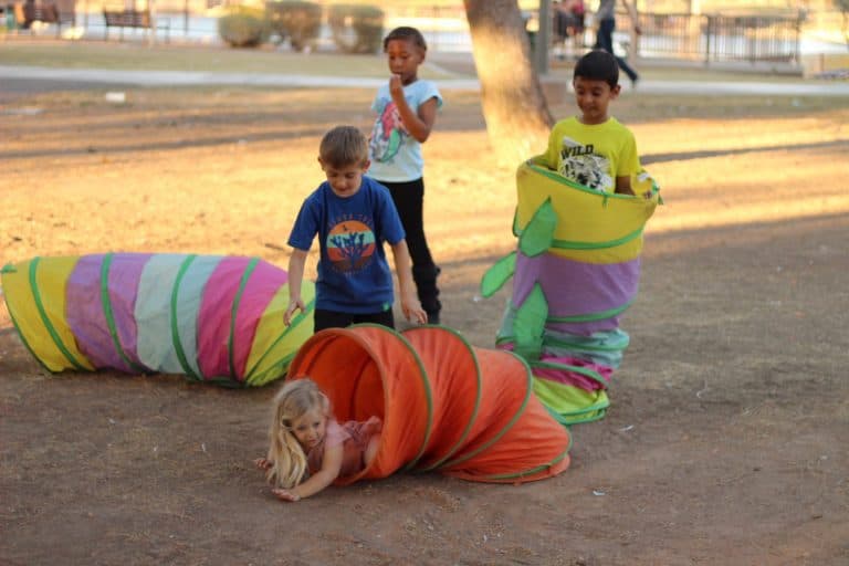Children playing with colorful tunnels.