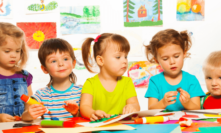 Preschool children making art in class.
