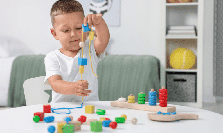 Toddler playing with colorful wooden toys.