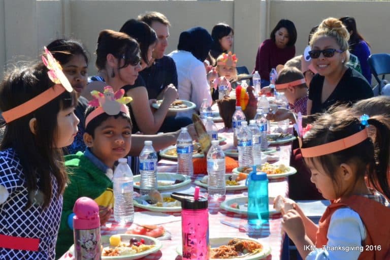 Kids celebrate Thanksgiving with food and drinks.