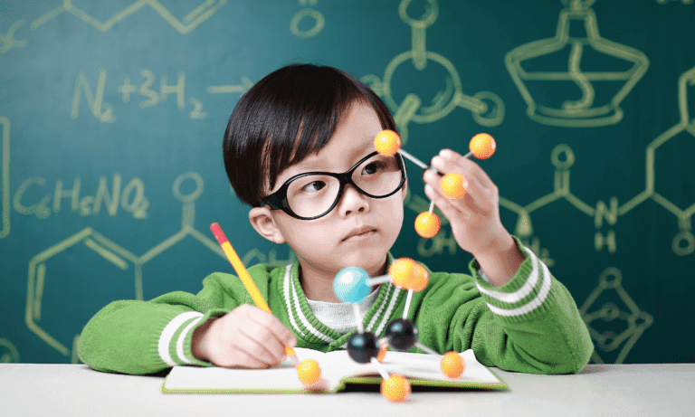 Child building a molecular model.