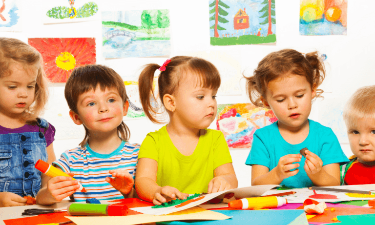 Preschool children making art in class.