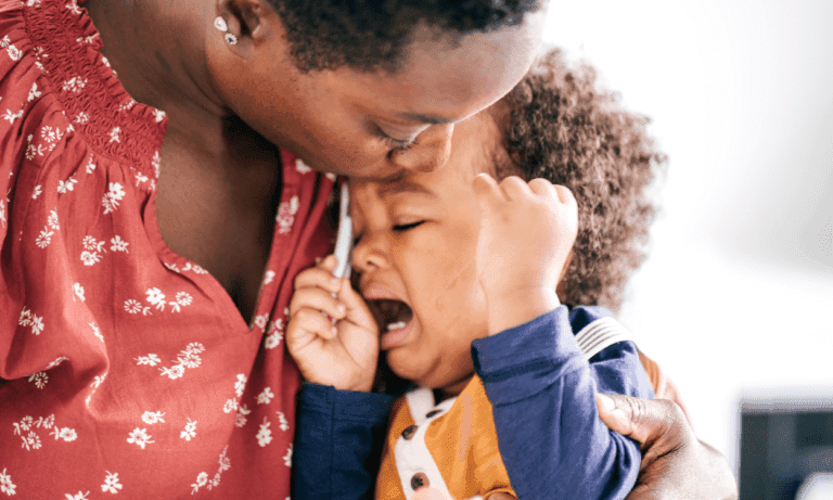 Mother comforting crying toddler.