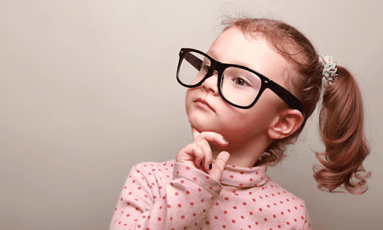 Girl in glasses thinking thoughtfully.