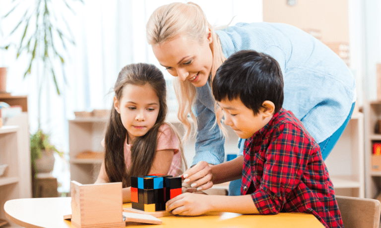 Teacher helping kids with colorful blocks.