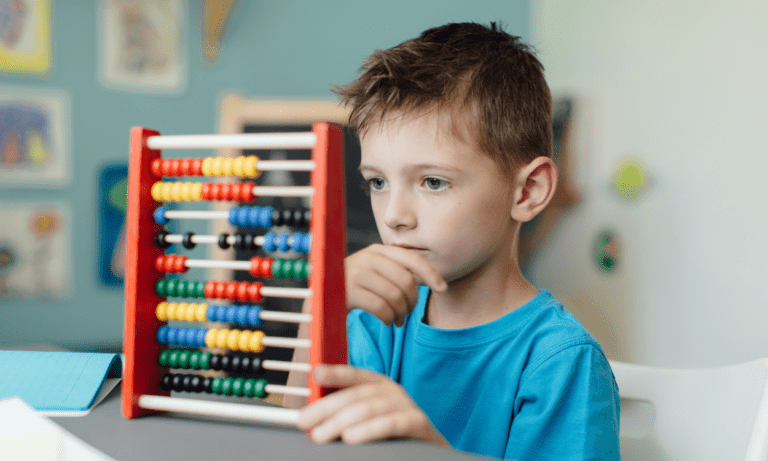 Boy using an abacus to learn math.
