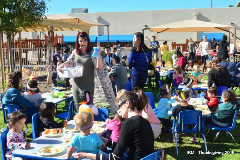 Children gather for Thanksgiving feast.