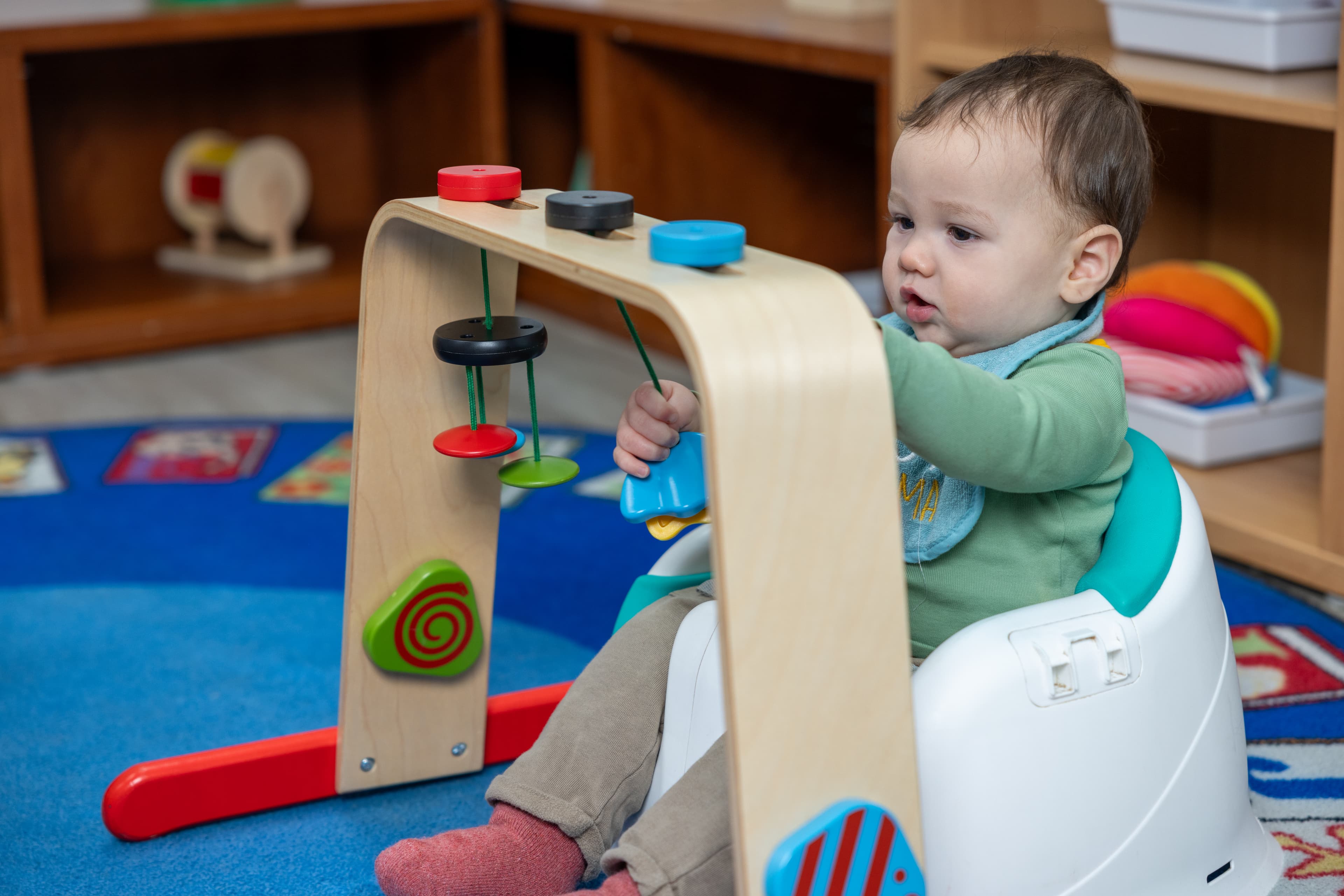 Infant playing with string toy