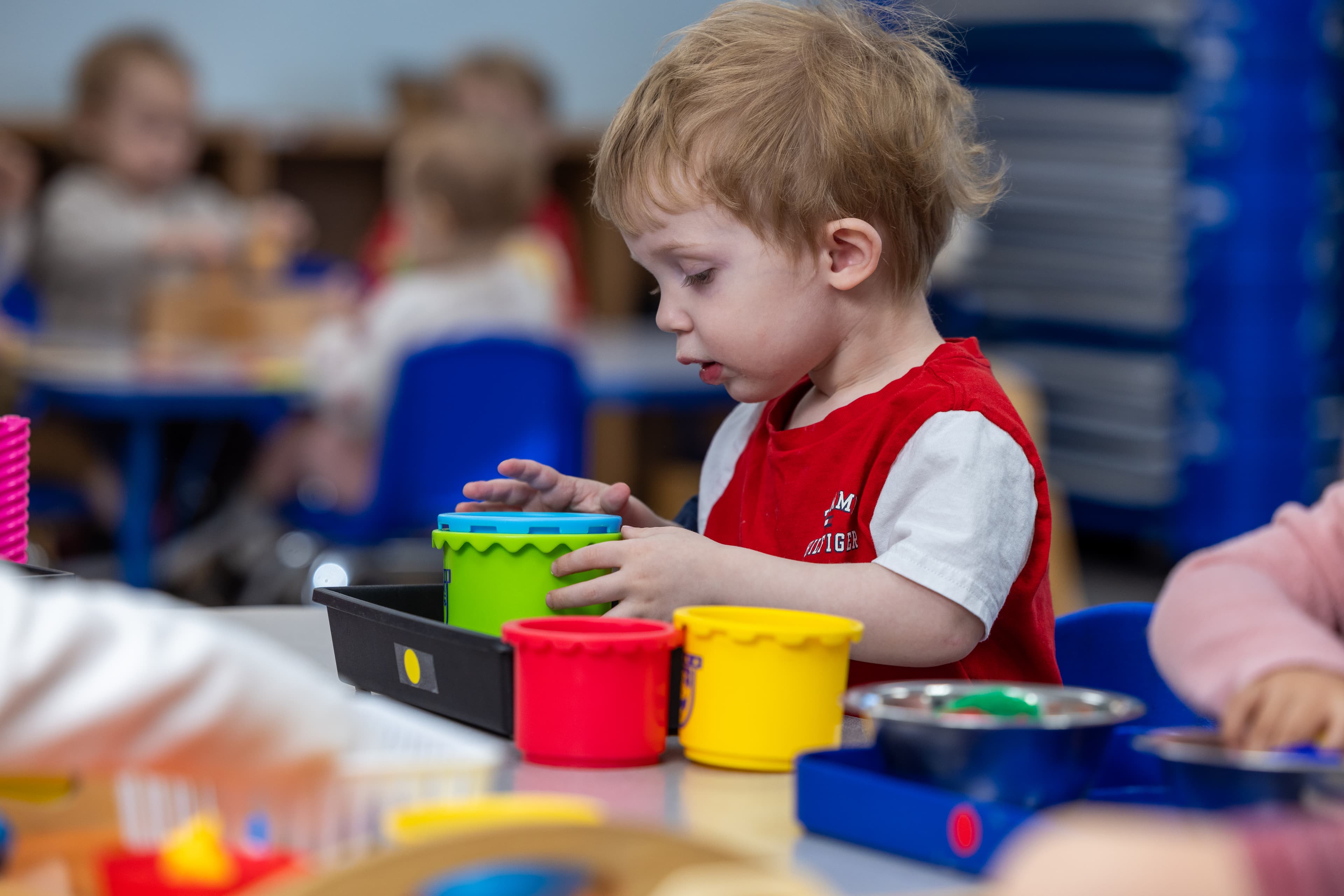 Pre-Primary student playing with buckets